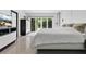 Bright bedroom with a modern design, a large bed, and sliding glass doors to the outside at 2525 Venetian Way, Winter Park, FL 32789