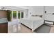 This spacious bedroom features a modern design, bright lighting, and access to an outdoor view at 2525 Venetian Way, Winter Park, FL 32789
