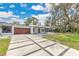 Modern home featuring a statement driveway, manicured lawn and unique architectural elements at 2525 Venetian Way, Winter Park, FL 32789