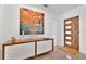 Inviting entryway with modern art and a stylish wooden door with glass inserts at 2525 Venetian Way, Winter Park, FL 32789