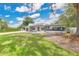 Contemporary home boasts a manicured lawn, complemented by the home's sleek lines and modern landscape design at 2525 Venetian Way, Winter Park, FL 32789