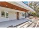 Covered front porch features a statement door, stone accents and modern exterior finishes at 2525 Venetian Way, Winter Park, FL 32789