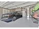 Spacious garage featuring a sleek black car, organized storage, and ample room for vehicles and equipment at 2525 Venetian Way, Winter Park, FL 32789