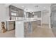 Modern kitchen features sleek gray cabinets, stainless appliances, a white quartz countertop and an island with bar seating at 2525 Venetian Way, Winter Park, FL 32789