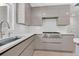 Bright kitchen featuring sleek, modern cabinets, stainless steel appliances, and a stylish faucet at 2525 Venetian Way, Winter Park, FL 32789