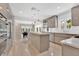Bright, modern kitchen with stainless steel appliances and a view to the dining area at 2525 Venetian Way, Winter Park, FL 32789