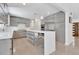 Modern kitchen offers sleek gray cabinets, stainless appliances, a white quartz countertop, and stylish bar seating at 2525 Venetian Way, Winter Park, FL 32789