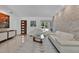 Bright living room with white sofas, a glass coffee table, and a decorative stone accent wall at 2525 Venetian Way, Winter Park, FL 32789