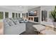 Comfortable living area featuring modern seating, stone fireplace, and large windows at 2525 Venetian Way, Winter Park, FL 32789