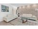 Cozy living room featuring white sofas, stone accent wall, and modern decor at 2525 Venetian Way, Winter Park, FL 32789