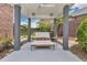 Inviting covered patio featuring stylish lounge furniture, decorative accents, and a relaxing view of the landscaped backyard at 2525 Venetian Way, Winter Park, FL 32789