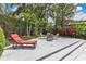 Landscaped backyard patio featuring a lounge chair and seating area at 2525 Venetian Way, Winter Park, FL 32789