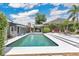 Backyard pool area with a covered seating area and lush landscaping at 2525 Venetian Way, Winter Park, FL 32789