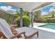 Beautifully landscaped backyard featuring a sparkling pool, comfortable lounge seating, and lush greenery at 2525 Venetian Way, Winter Park, FL 32789