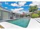 In-ground swimming pool with modern pool house and patio at 2525 Venetian Way, Winter Park, FL 32789