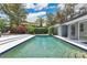 Lush backyard featuring a clear blue swimming pool, manicured landscaping, and an inviting outdoor space at 2525 Venetian Way, Winter Park, FL 32789