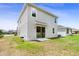 The house has a grassy backyard with a sliding glass door to the patio, ideal for outdoor entertaining at 2680 Nottel Dr, St Cloud, FL 34772