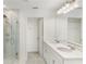 Elegant bathroom with dual sinks, walk-in shower, and white marble at 2680 Nottel Dr, St Cloud, FL 34772