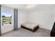 This minimalist bedroom has large window, letting in lots of light, with water views and easy access to a TV at 2680 Nottel Dr, St Cloud, FL 34772