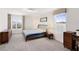 Bright bedroom with carpet, two windows, and dressers at 2680 Nottel Dr, St Cloud, FL 34772