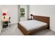 This bright bedroom is minimalist and features a large window and desk, creating a peaceful ambiance at 2680 Nottel Dr, St Cloud, FL 34772