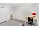 This minimalist bedroom features a small desk and bright red lamp that adds a touch of personality to the space at 2680 Nottel Dr, St Cloud, FL 34772
