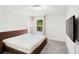 This bright bedroom is minimalist and features a large window and a modern ceiling light at 2680 Nottel Dr, St Cloud, FL 34772
