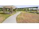 A well-maintained pathway meanders through the community park, leading to a covered picnic spot and a dock at 2680 Nottel Dr, St Cloud, FL 34772