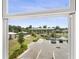 View from the window showcases the community amenities, including a parking lot, park, and a covered dock by the water at 2680 Nottel Dr, St Cloud, FL 34772
