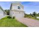 View of the home, highlighting its manicured lawn, attached garage, and modern architectural design at 2680 Nottel Dr, St Cloud, FL 34772