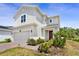 Attractive home with a two-car garage, complemented by lush landscaping and a brick-paved driveway at 2680 Nottel Dr, St Cloud, FL 34772