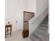 Inviting foyer featuring a staircase, modern lighting fixture, and decorative wooden panel at 2680 Nottel Dr, St Cloud, FL 34772