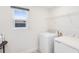 Clean laundry room with white washer, dryer, and shelf at 2680 Nottel Dr, St Cloud, FL 34772