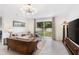 Comfortable living room with large windows, neutral decor and backyard views at 2680 Nottel Dr, St Cloud, FL 34772