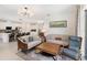 Open-concept living room featuring neutral decor, comfortable seating and seamless kitchen access at 2680 Nottel Dr, St Cloud, FL 34772