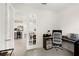 Office space with French doors leading to the kitchen, featuring neutral decor at 2680 Nottel Dr, St Cloud, FL 34772