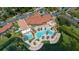 Aerial shot of the community pool, waterslide, clubhouse and surrounding lake and landscaping at 2718 Bushman Dr, Kissimmee, FL 34746
