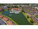 Aerial view of the community pool and clubhouse with a scenic lake view at 2718 Bushman Dr, Kissimmee, FL 34746