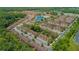 Spacious community featuring well-maintained townhomes, lush landscaping, a tranquil pond, and abundant parking at 2718 Bushman Dr, Kissimmee, FL 34746