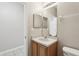 Well-lit bathroom features a vanity with sink, mirror, and a toilet at 2718 Bushman Dr, Kissimmee, FL 34746
