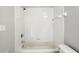 Bathroom with tub, shower, white tile and neutral walls at 2718 Bushman Dr, Kissimmee, FL 34746