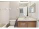 Functional bathroom with white tile, vanity with sink, and a wall mirror at 2718 Bushman Dr, Kissimmee, FL 34746