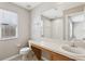 Bright bathroom with tile floor, vanity with sink, and a large wall mirror at 2718 Bushman Dr, Kissimmee, FL 34746
