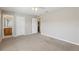 Bedroom features carpeted floors, neutral walls, ceiling fan, and ensuite bathroom at 2718 Bushman Dr, Kissimmee, FL 34746