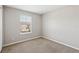 Bedroom features neutral carpet, a window with blinds, and neutral paint at 2718 Bushman Dr, Kissimmee, FL 34746