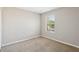 Cozy bedroom featuring neutral walls, plush carpet, and a window offering natural light at 2718 Bushman Dr, Kissimmee, FL 34746