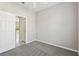 Bedroom with neutral paint, carpet, and door to another room at 2718 Bushman Dr, Kissimmee, FL 34746