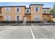 Two-story condo with parking in front, decorative shutters, and arched doorway at 2718 Bushman Dr, Kissimmee, FL 34746