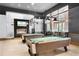 Well-lit game room features pool tables, a fireplace, and lounge area with outdoor views at 2718 Bushman Dr, Kissimmee, FL 34746