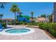 Inviting hot tub with surrounding greenery and a waterslide in the background at 2718 Bushman Dr, Kissimmee, FL 34746
